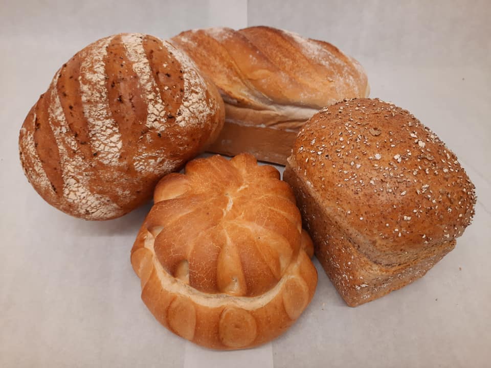 Photo of four artisan loaves of bread